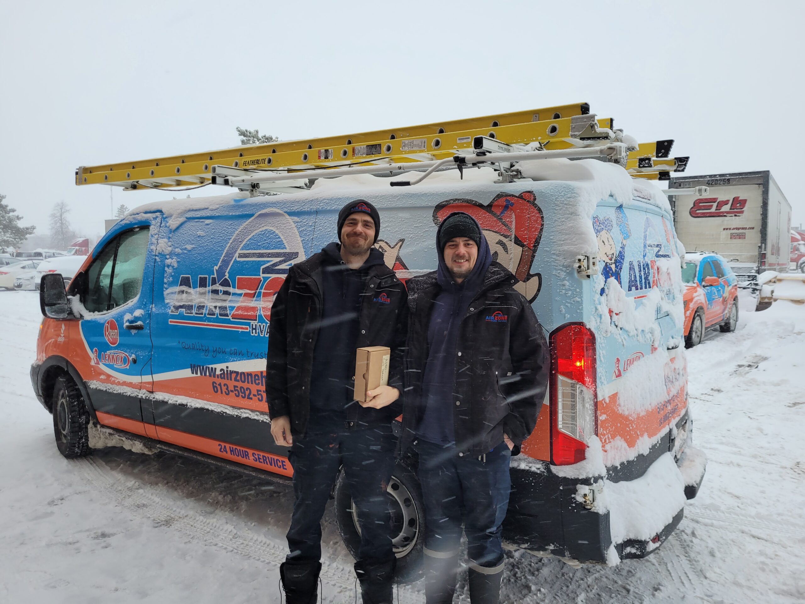 AirZone boiler service team beside an Ottawa service vehicle during winter