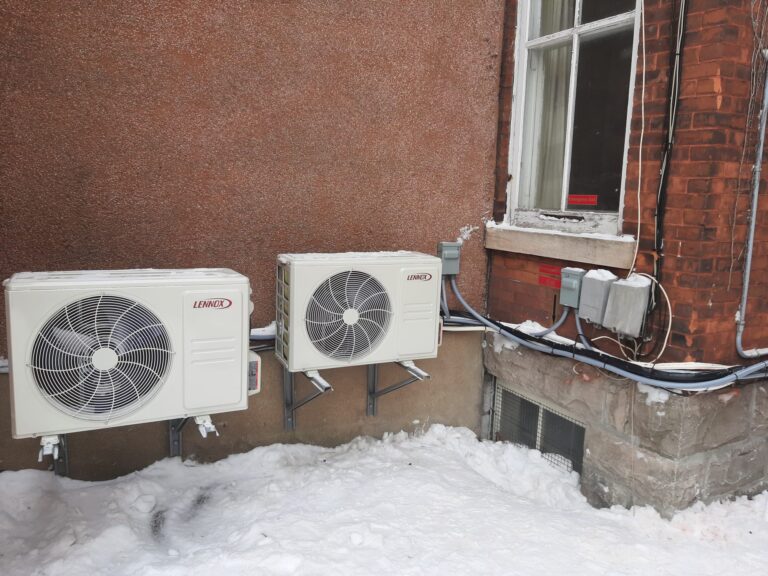 Two Lennox MLB outdoor units installed beside a home