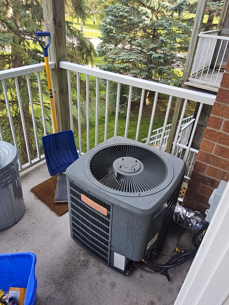Original Goodman top-discharge air conditioner on the balcony of a Hunt Club home